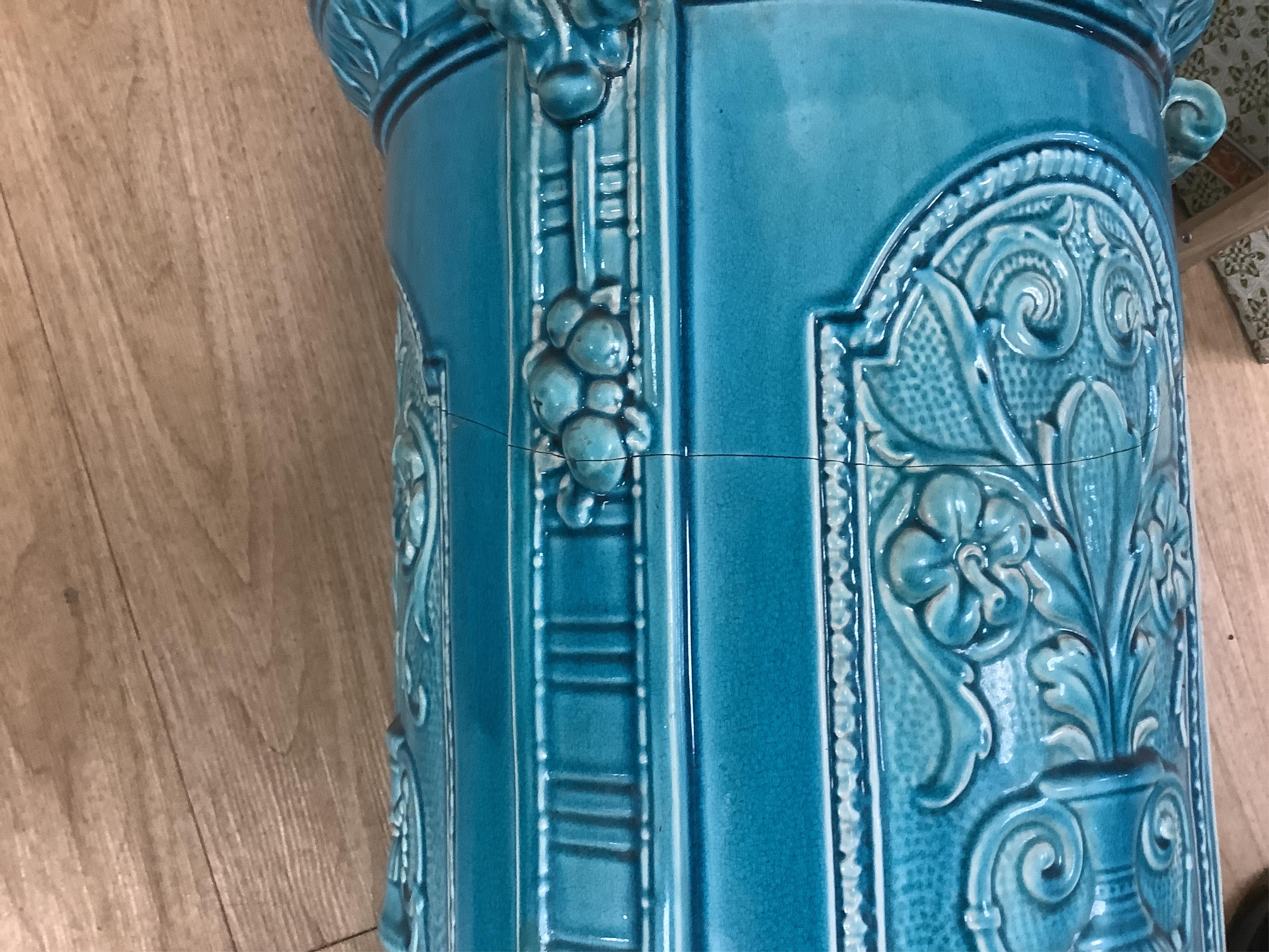 A Burmantofts style turquoise glazed jardiniere and a similar larger stand, decorated in relief, 90cm high